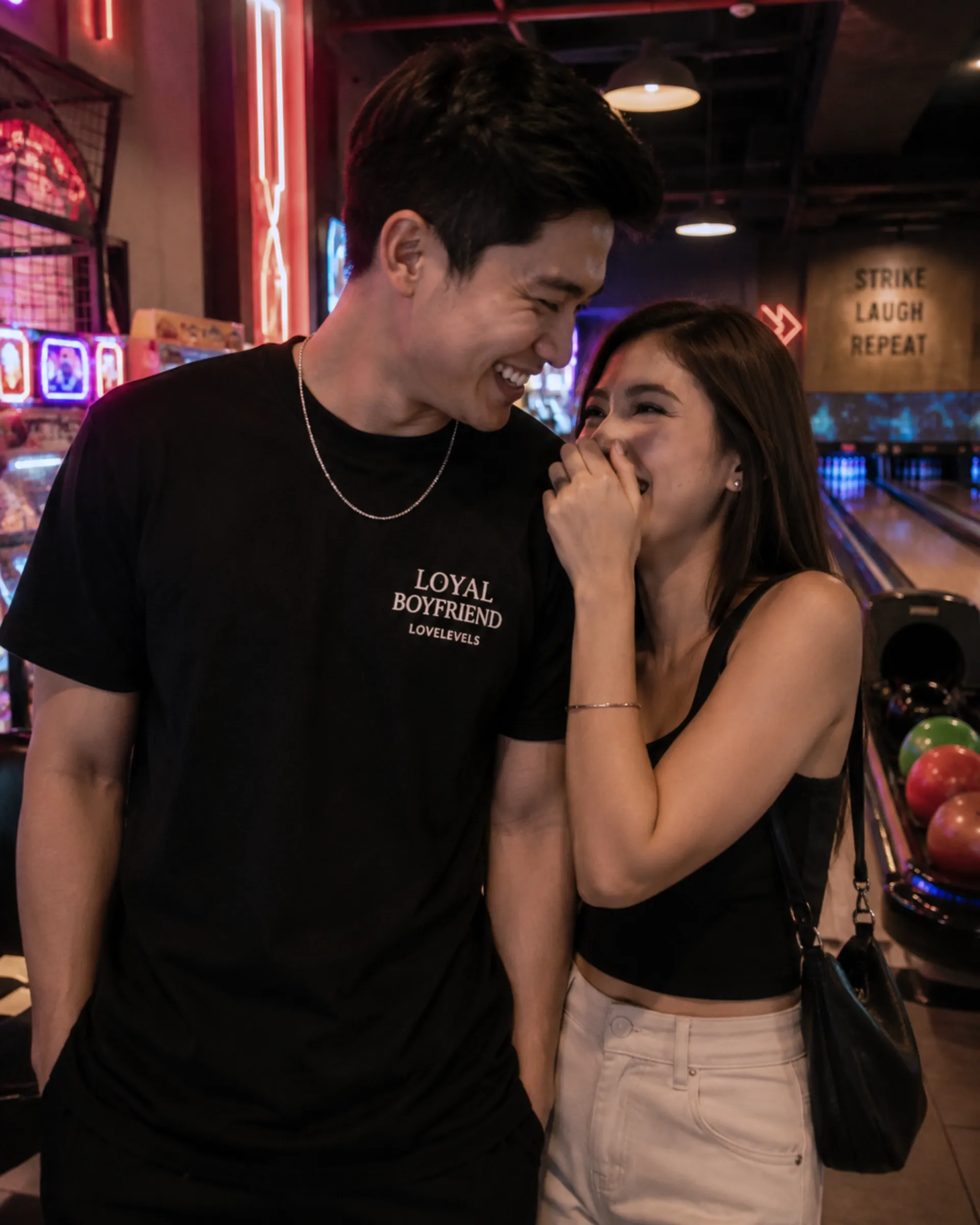A Filipino couple enjoying an arcade date with a relationship statement shirt_wp A Filipino couple enjoying an arcade date with a relationship statement shirt_wp