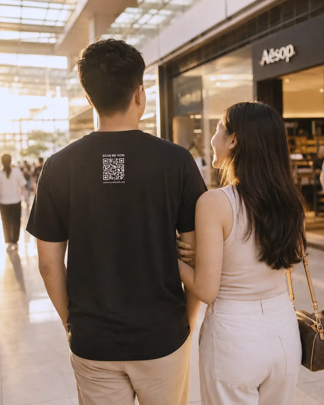 Filipino couple on a warm mall date with a LoveLevels QR shirt visible from the back. WP Filipino couple on a warm mall date with a LoveLevels QR shirt visible from the back. WP