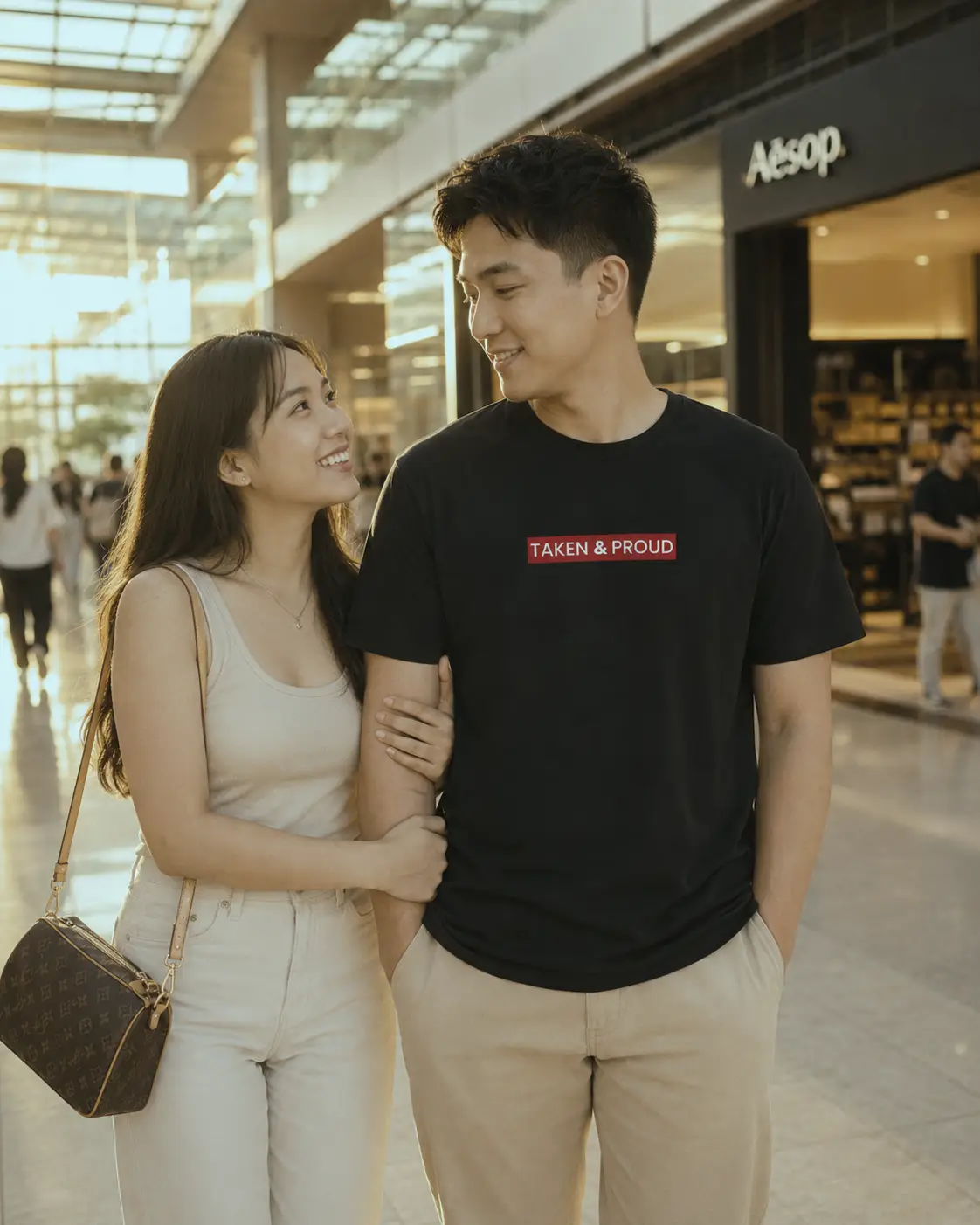 Filipino couple smiling in a mall while the man wears a “Taken & Proud” LoveLevels shirt. WP Filipino couple smiling in a mall while the man wears a “Taken & Proud” LoveLevels shirt. WP