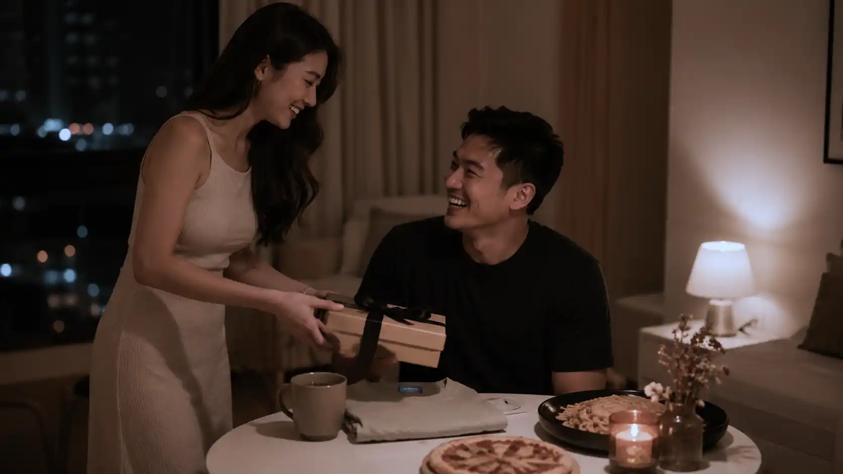 Romantic personalized gift moment between a Filipino wife and husband during a cozy staycation date night